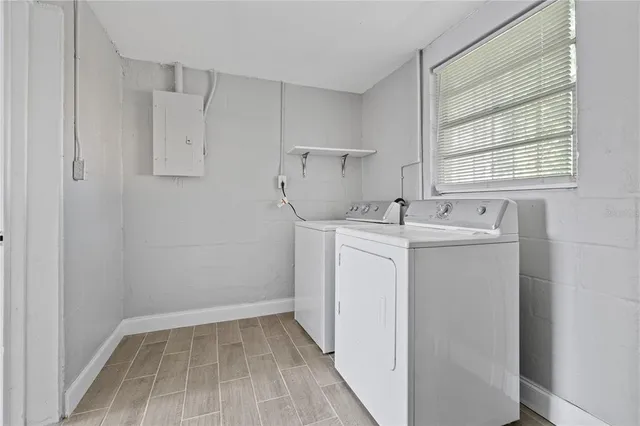 a utility room with sink dryer and washer
