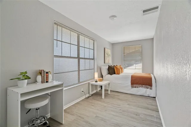 a bedroom with furniture and a window