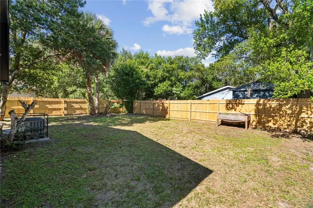 a view of a house with a yard and garage