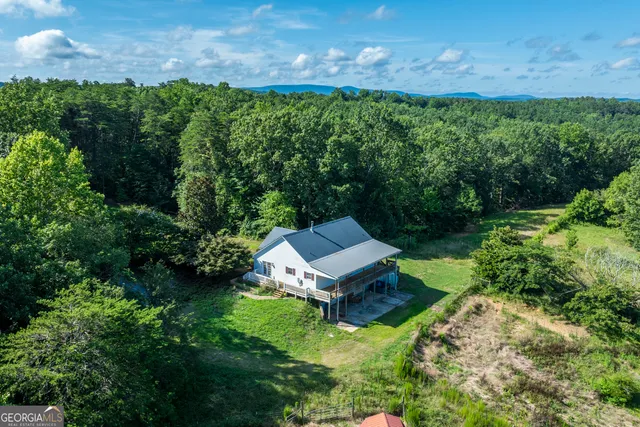an aerial view of a house with a yard