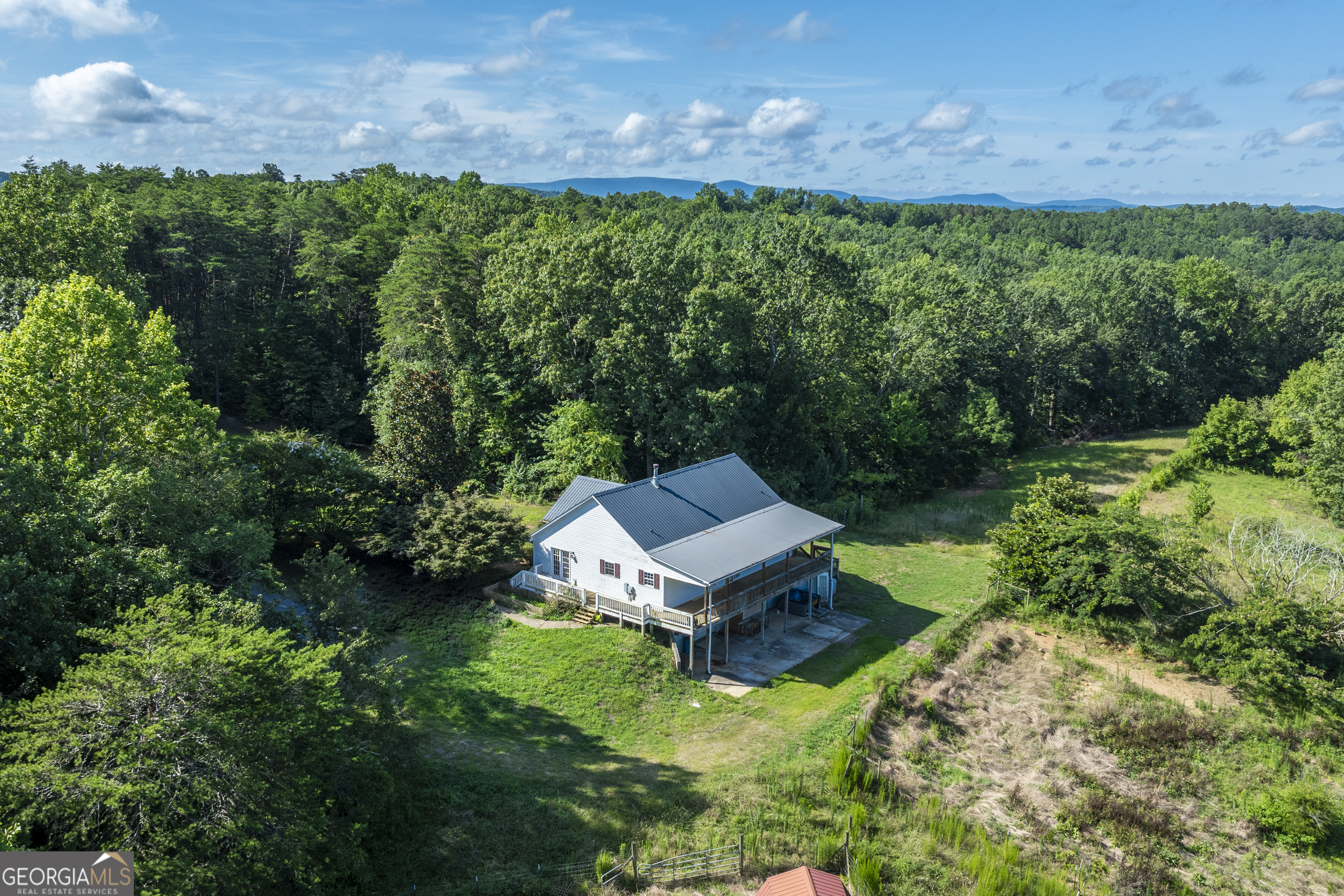 an aerial view of a house with a yard