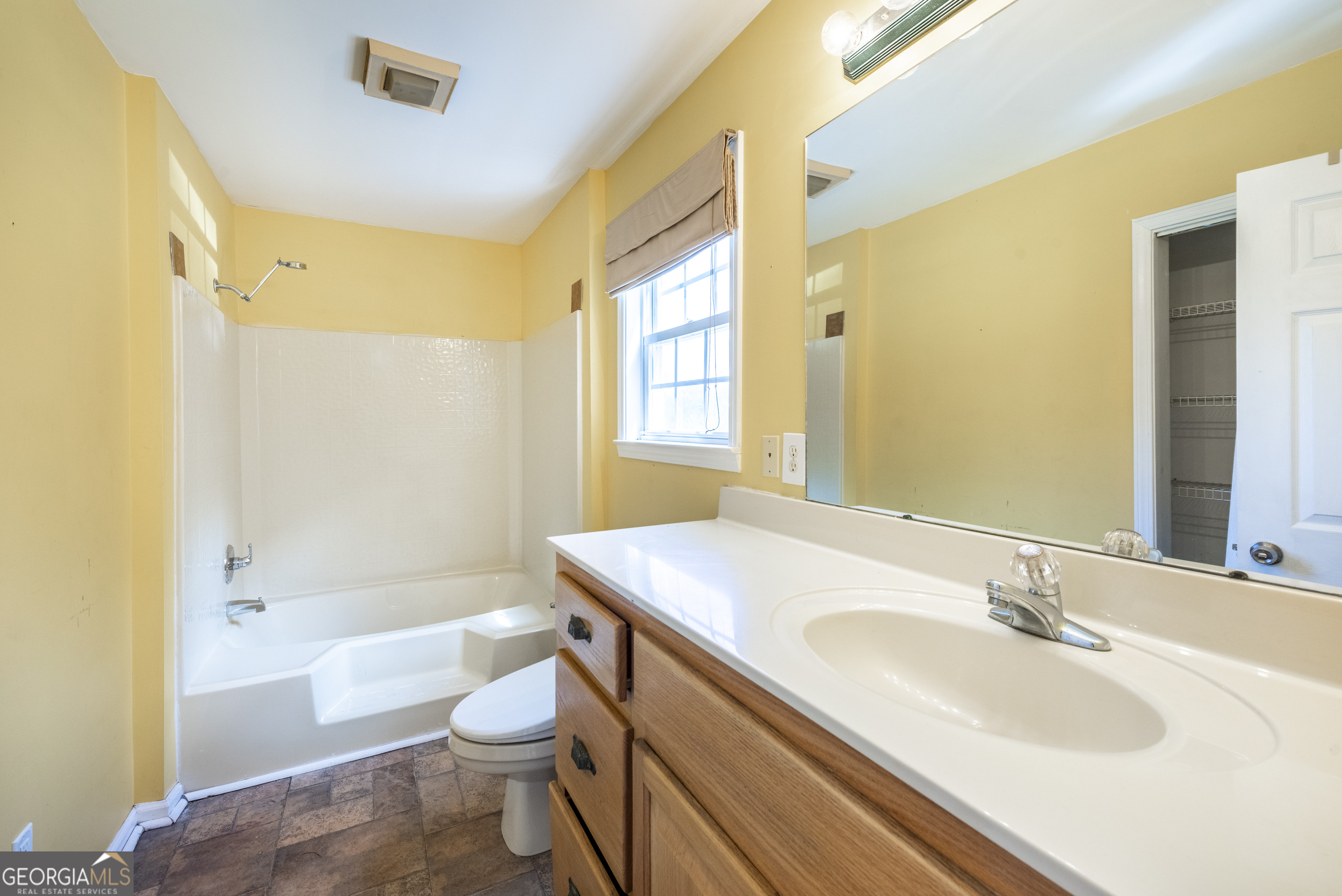 157 Edwards Road Fairmount, GA 30139 - Photo 23 of 72 a bathroom with a granite countertop sink a toilet a mirror and bathtub