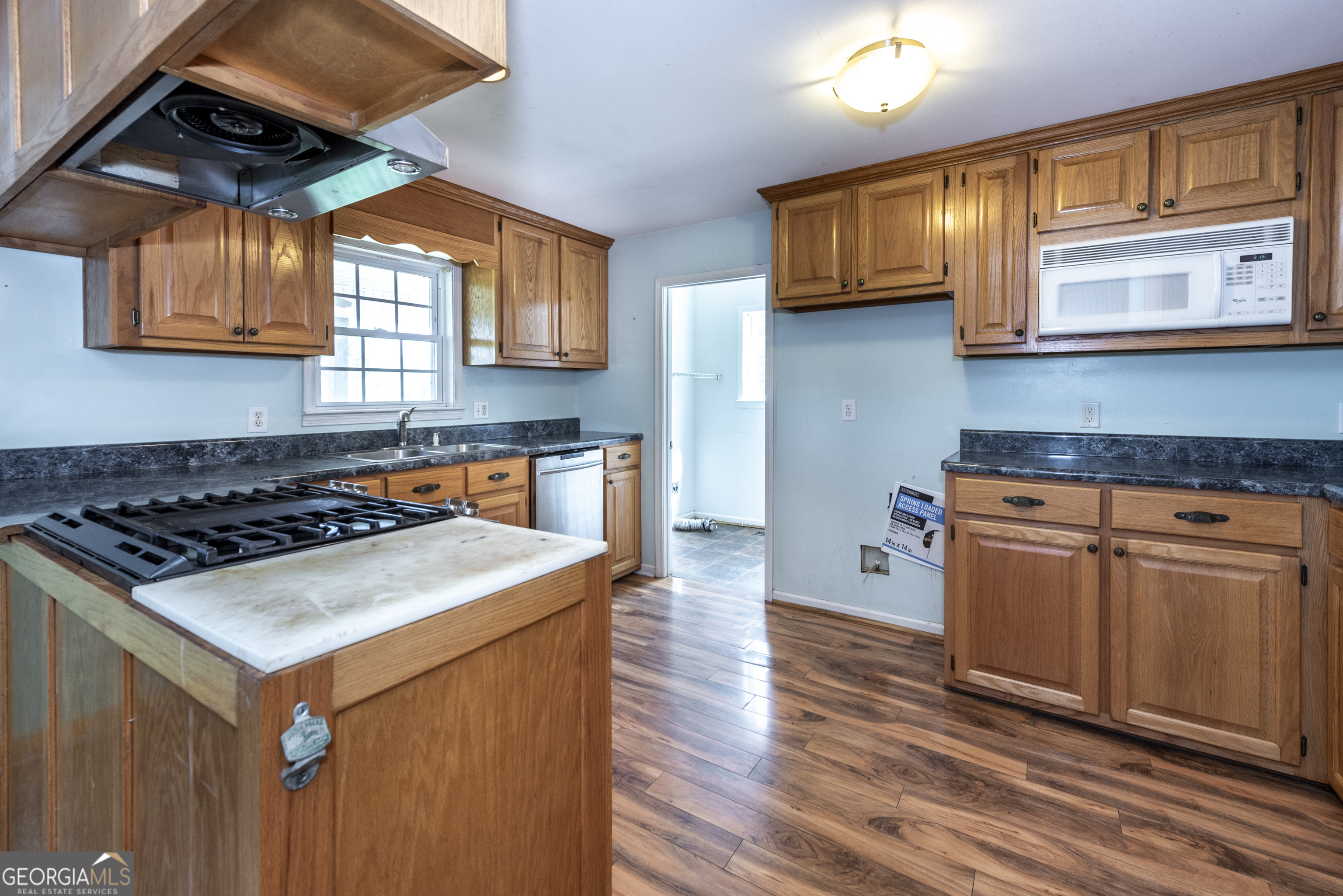157 Edwards Road Fairmount, GA 30139 - Photo 27 of 72 a kitchen with stainless steel appliances granite countertop a stove a sink and a microwave