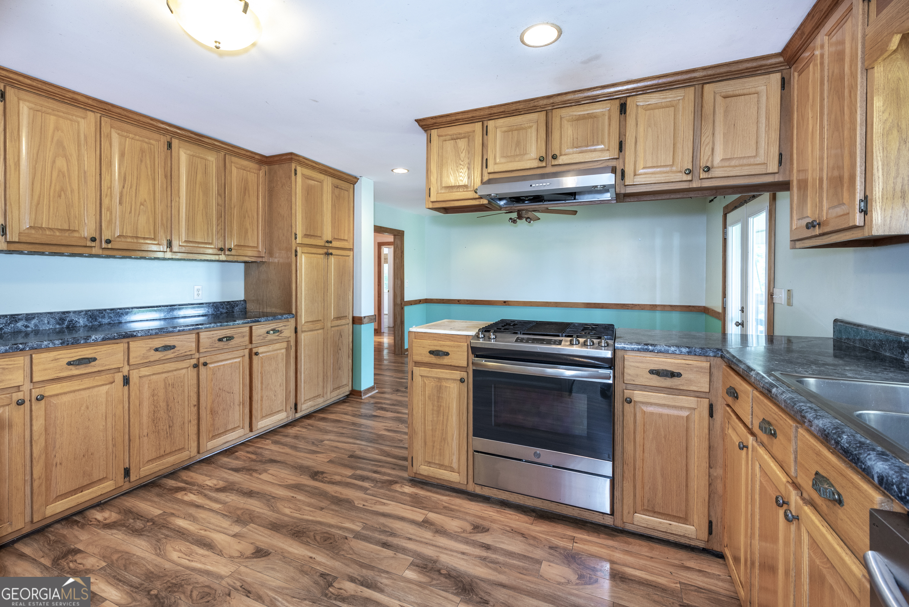 157 Edwards Road Fairmount, GA 30139 - Photo 29 of 72 a kitchen with stainless steel appliances granite countertop a stove a sink and a microwave