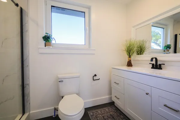 a bathroom with a sink a toilet and a mirror
