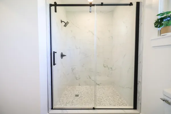 a bathroom with a glass shower door