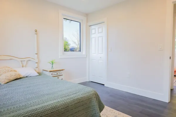a bedroom with a bed and wooden floor