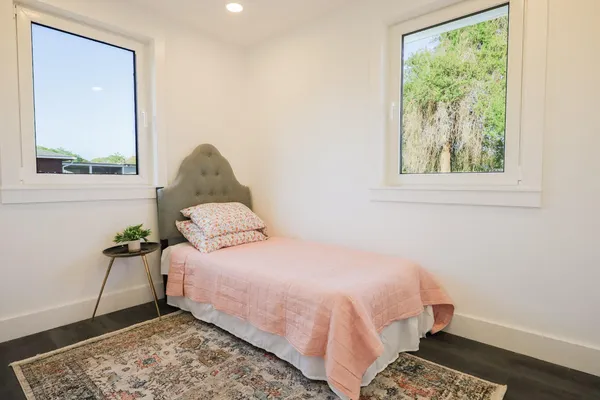 a bedroom with a bed and a window