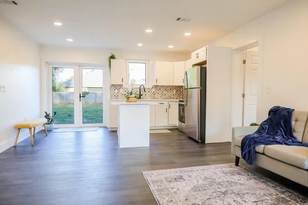 a living room with furniture and a wooden floor