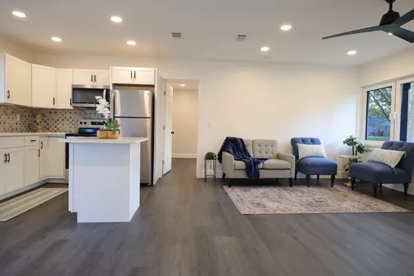 a living room with furniture and kitchen view