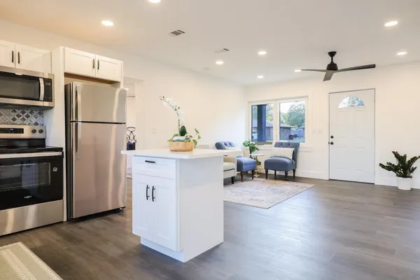 a kitchen with refrigerator and furniture
