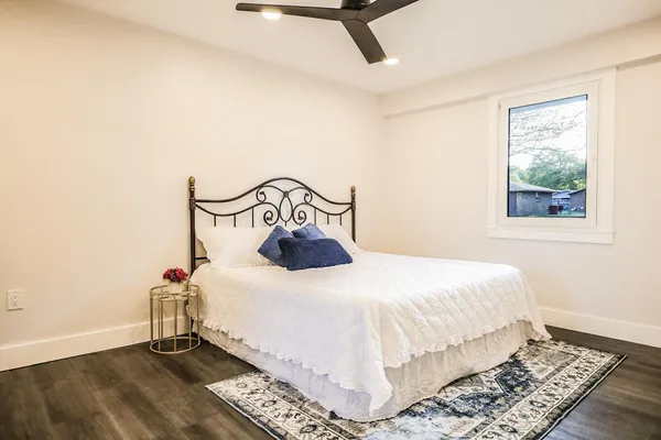 a bedroom with a bed and wooden floor