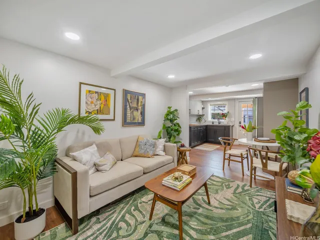 a living room with furniture potted plant and a window