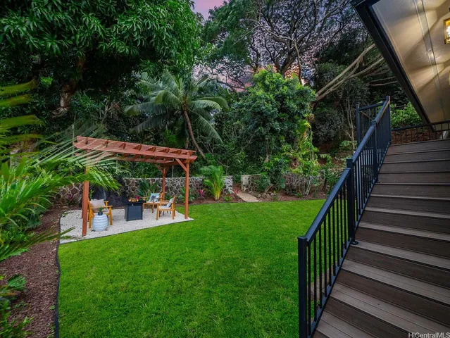 a view of a chair and table in the garden