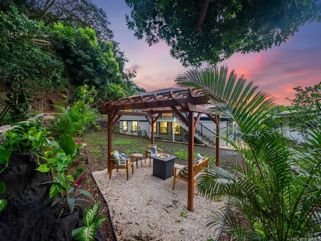 a view of a patio with table and chairs under an umbrella