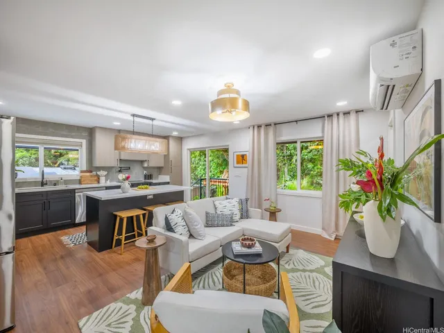 a living room with furniture a window and a dining table