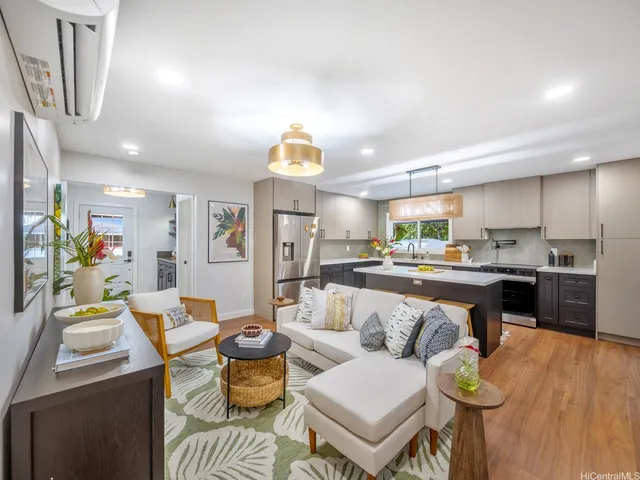 a living room with furniture and a kitchen view