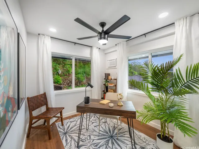 a view of a livingroom with furniture and a potted plant