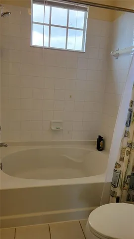 a bathroom with a toilet and a bath tub