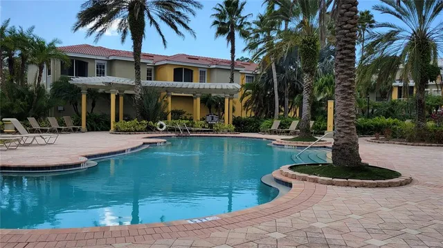 a view of a house with swimming pool and a sitting area