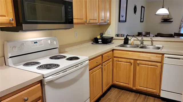 a kitchen with cabinets and appliances