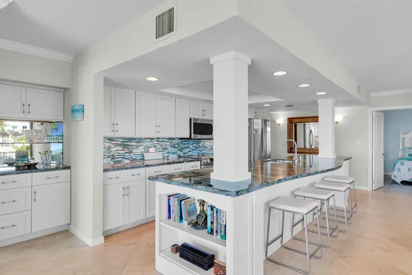 a kitchen with granite countertop cabinets a sink and appliances