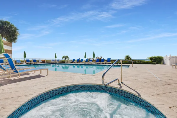 a living room with patio furniture and a garden