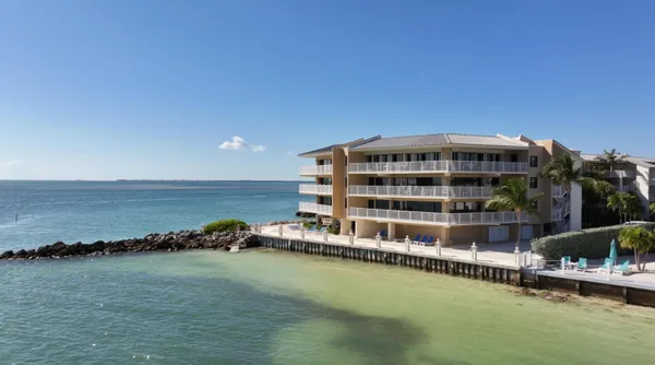 a view of a large body of water with tall building in back