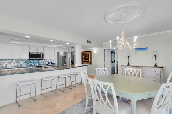 a large kitchen with a table and chairs