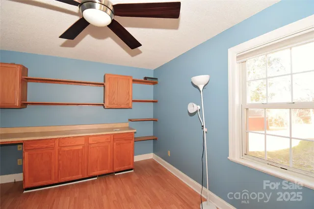 a room with wooden floor and window