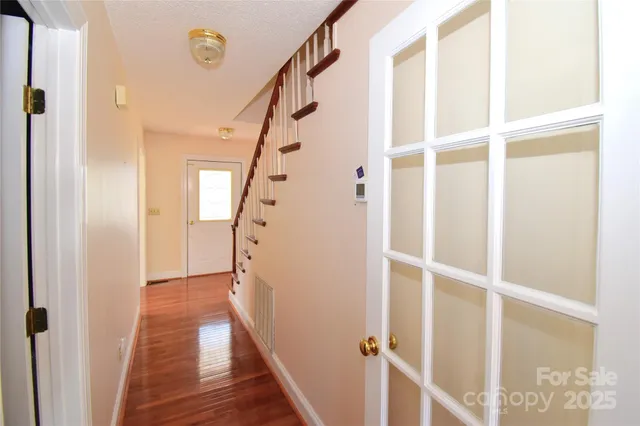 a view of entryway with wooden floor and stair