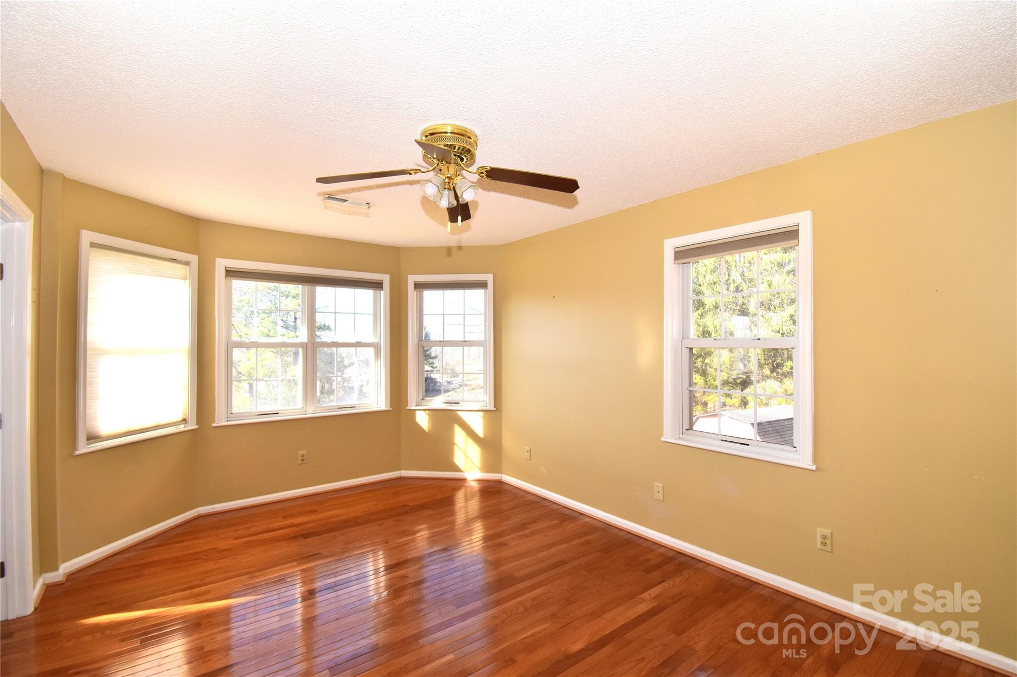 233 Ledbetter Road Arden, NC 28704 - Photo 15 of 45 a view of an empty room with a window and wooden floor