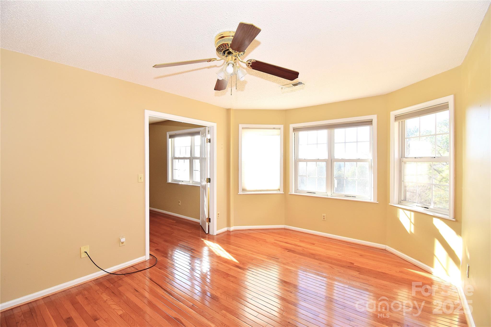 233 Ledbetter Road Arden, NC 28704 - Photo 16 of 45 a view of an empty room with a window and wooden floor