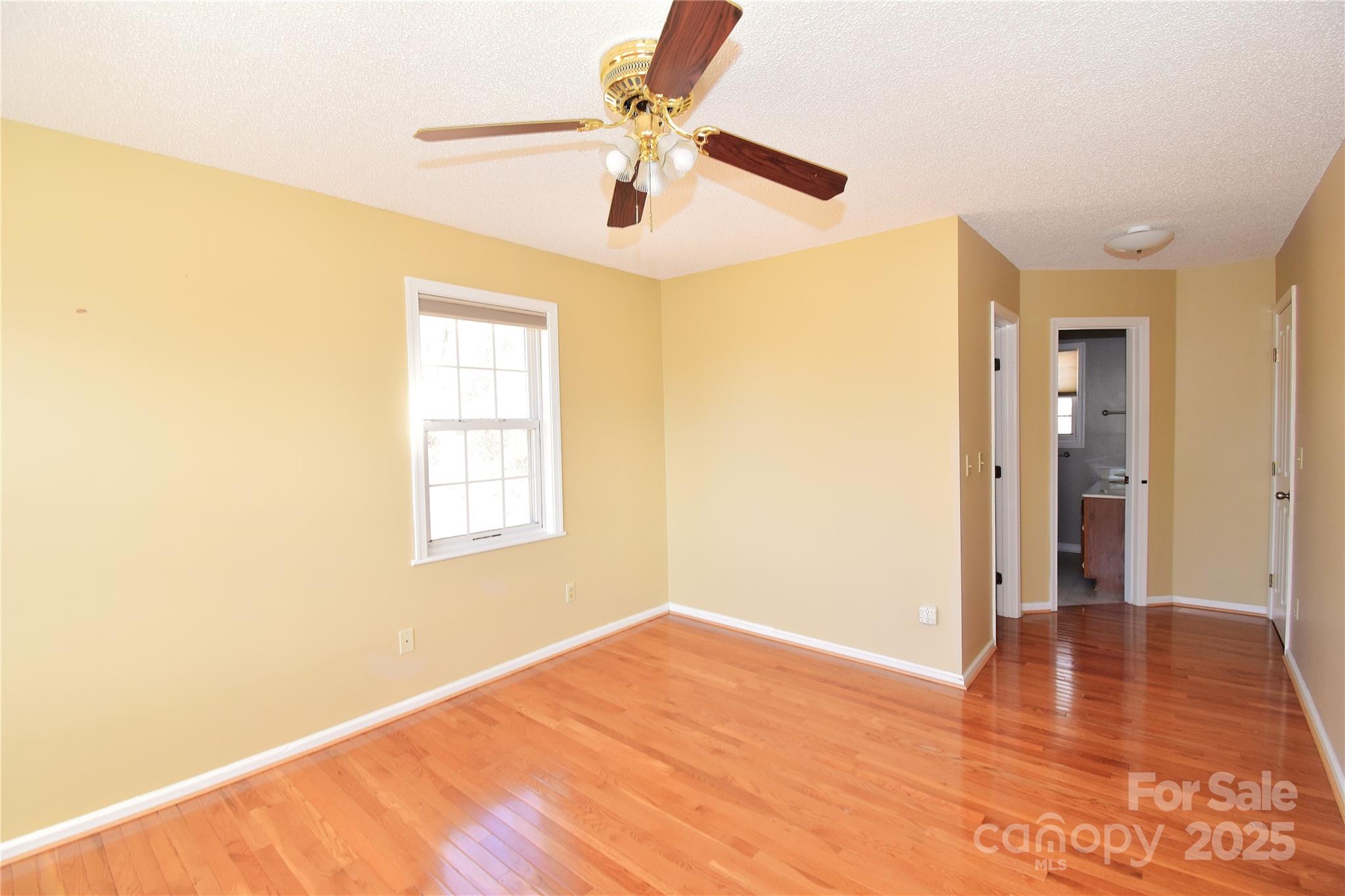 233 Ledbetter Road Arden, NC 28704 - Photo 20 of 45 a view of an empty room with wooden floor and a window