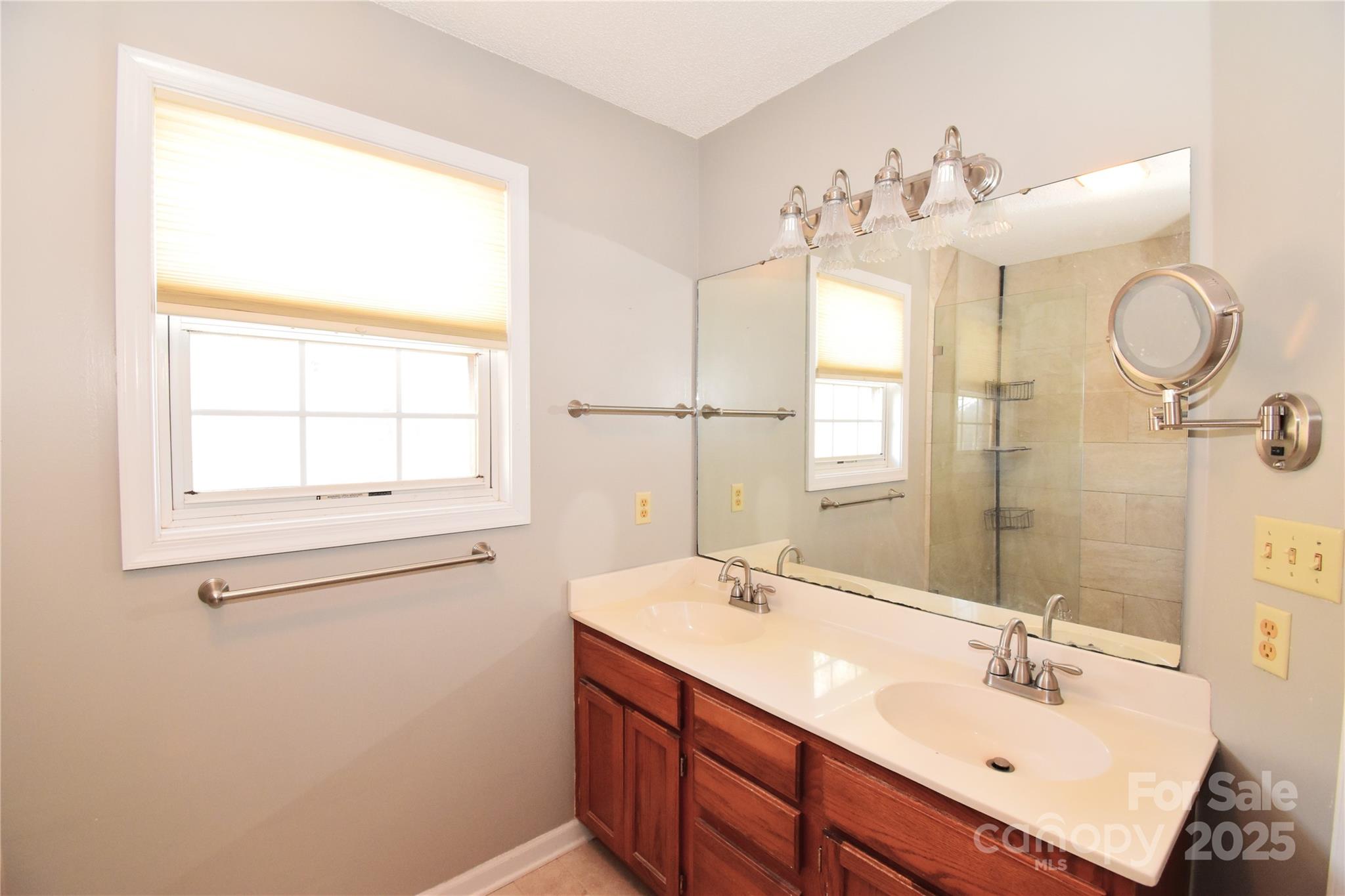 233 Ledbetter Road Arden, NC 28704 - Photo 23 of 45 a bathroom with a sink vanity and a mirror