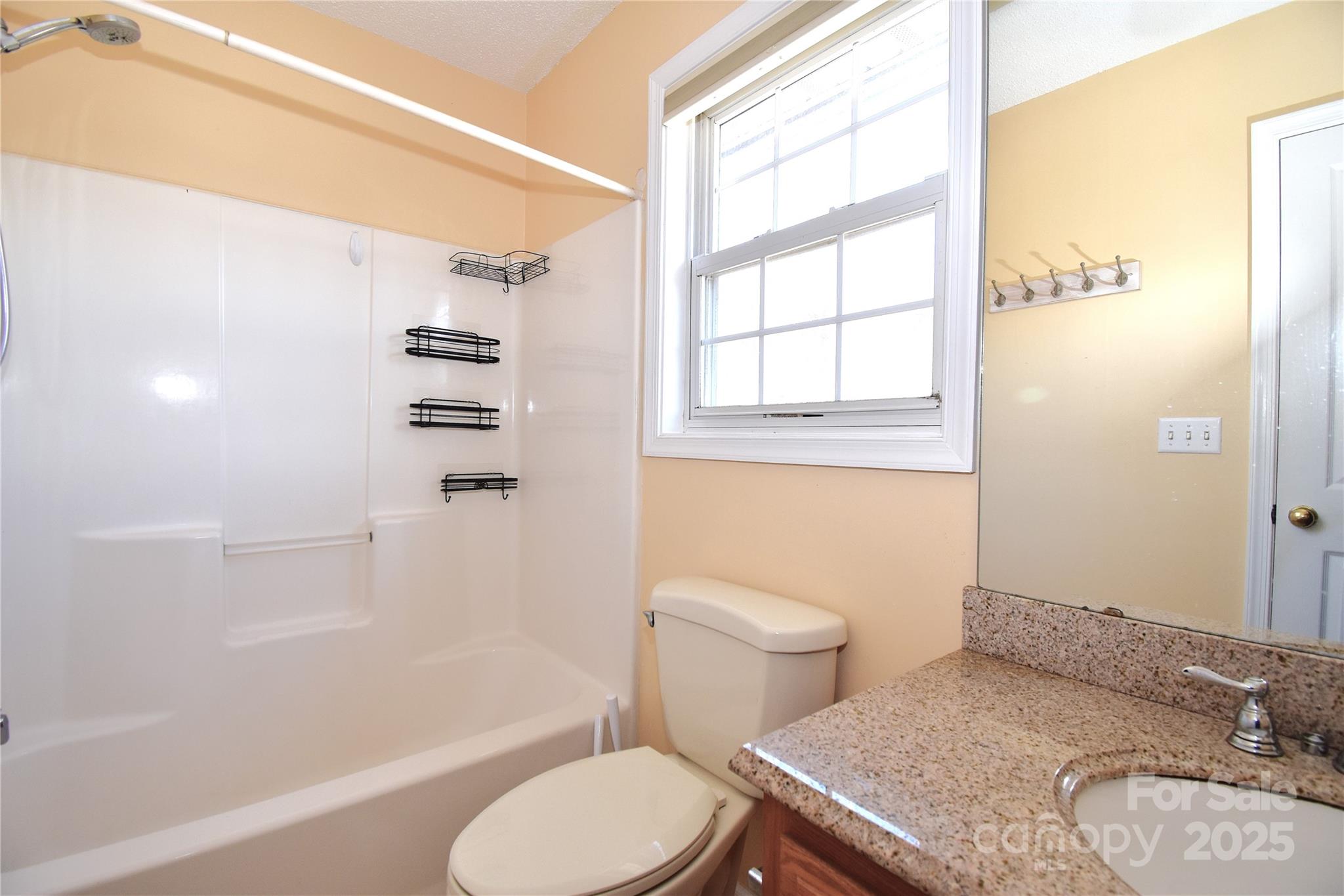 233 Ledbetter Road Arden, NC 28704 - Photo 27 of 45 a white toilet sitting next to a bath tub and a shower