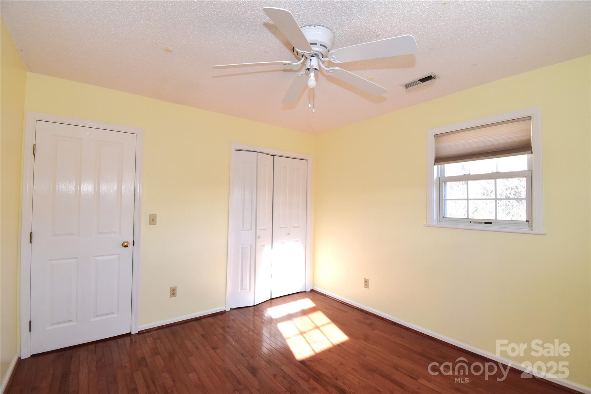 233 Ledbetter Road Arden, NC 28704 - Photo 29 of 45 a view of an empty room with wooden floor and a window