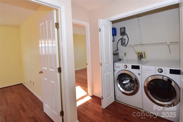 a view of a hallway with washer and dryer