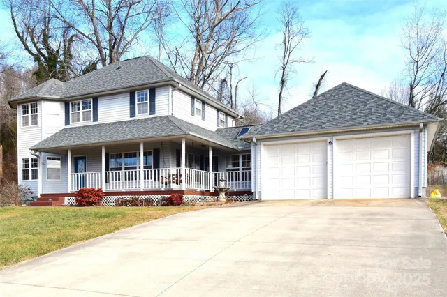 a front view of a house with garden and plants