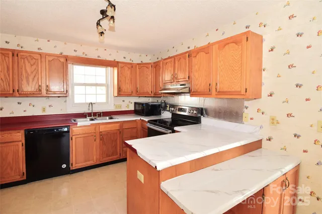 a kitchen with stainless steel appliances sink a microwave and cabinets
