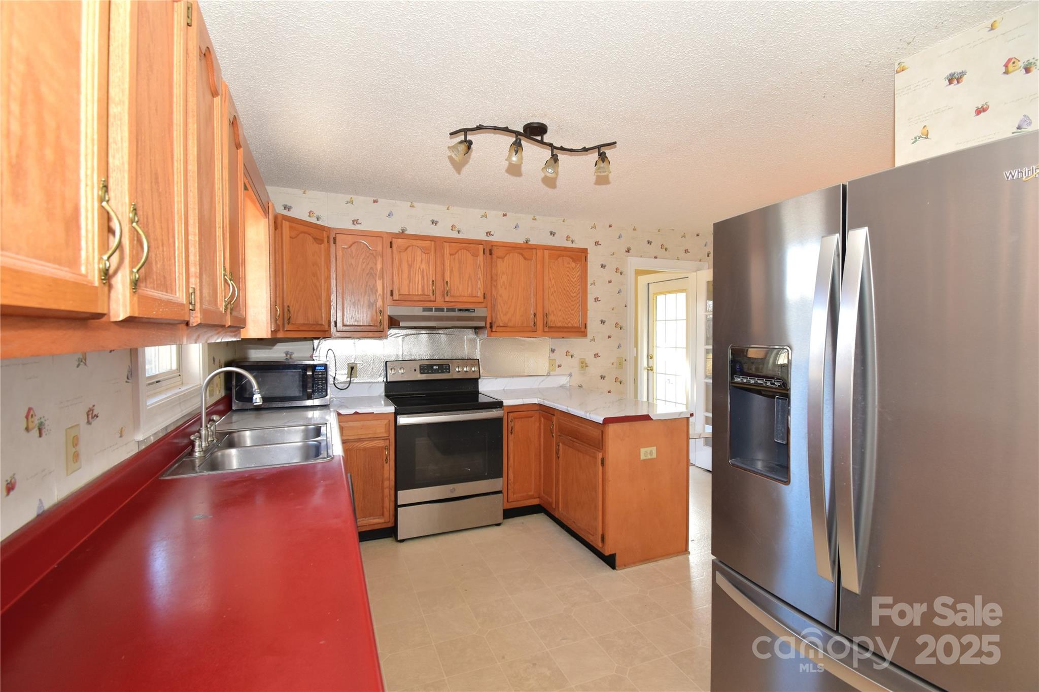 233 Ledbetter Road Arden, NC 28704 - Photo 7 of 45 a kitchen with granite countertop a refrigerator stove top oven and sink