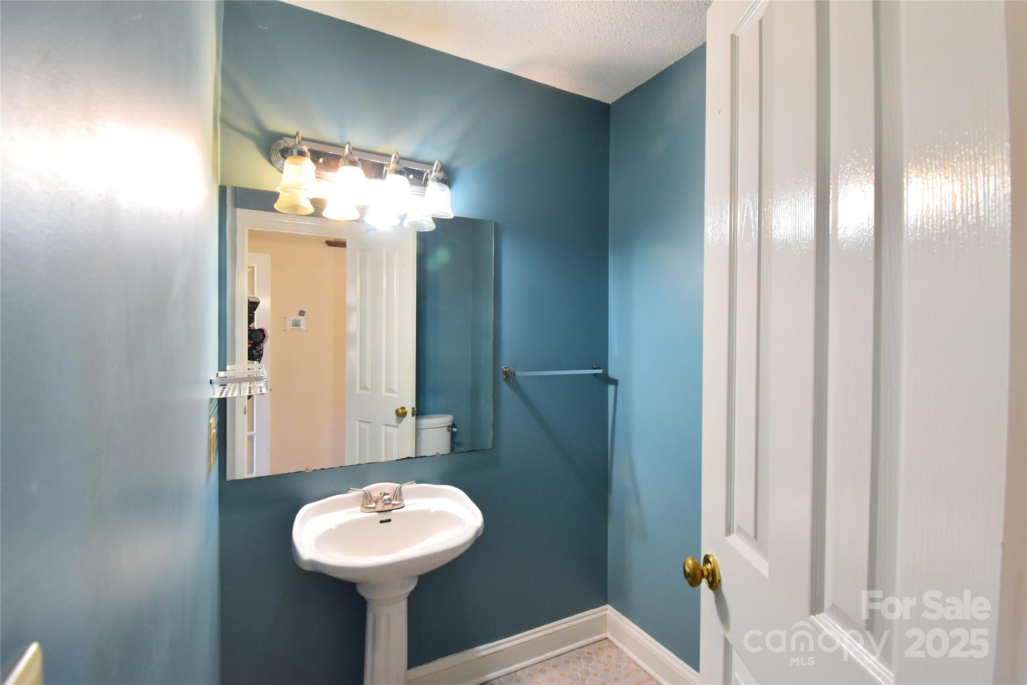 233 Ledbetter Road Arden, NC 28704 - Photo 9 of 45 a bathroom with a sink and a mirror