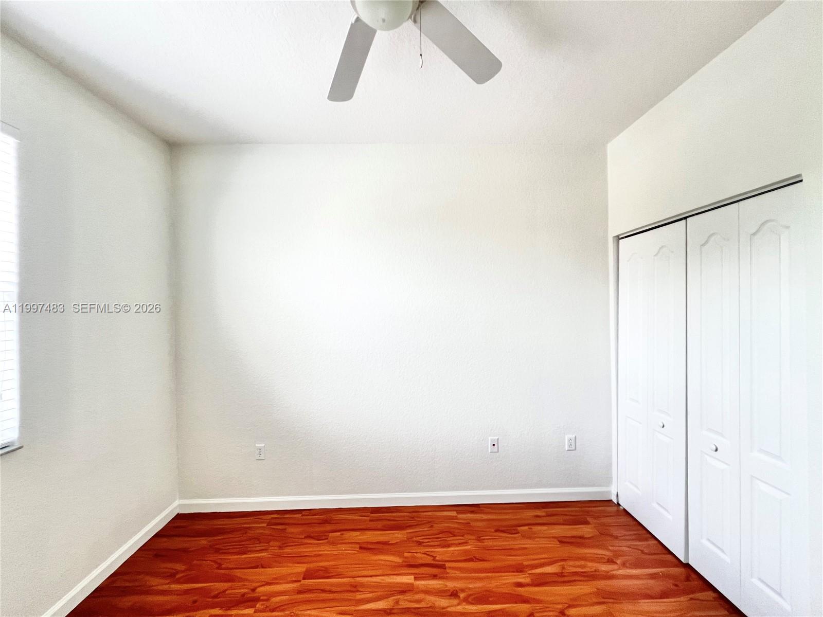 3910 Northeast 13th Drive Homestead, FL 33033 - Photo 11 of 35 a view of room with walk in closet and wooden floor