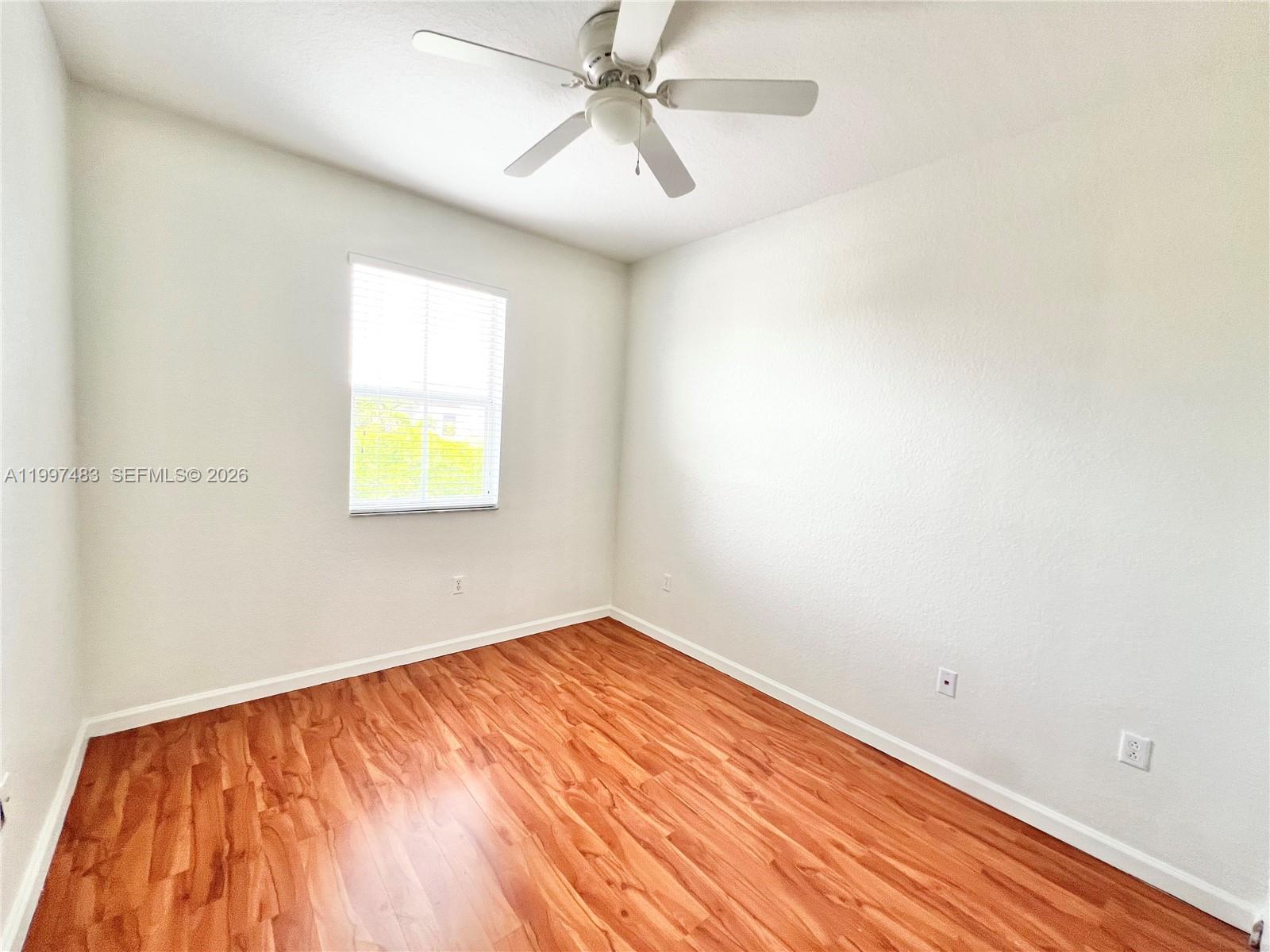 3910 Northeast 13th Drive Homestead, FL 33033 - Photo 12 of 35 an empty room with a window and a ceiling fan