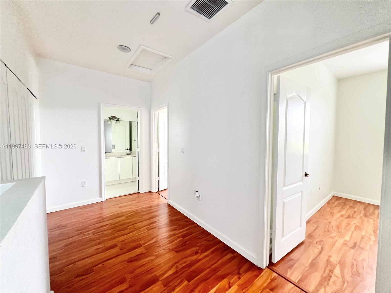 3910 Northeast 13th Drive Homestead, FL 33033 - Photo 13 of 35 a view of a room with wooden floor and bathroom
