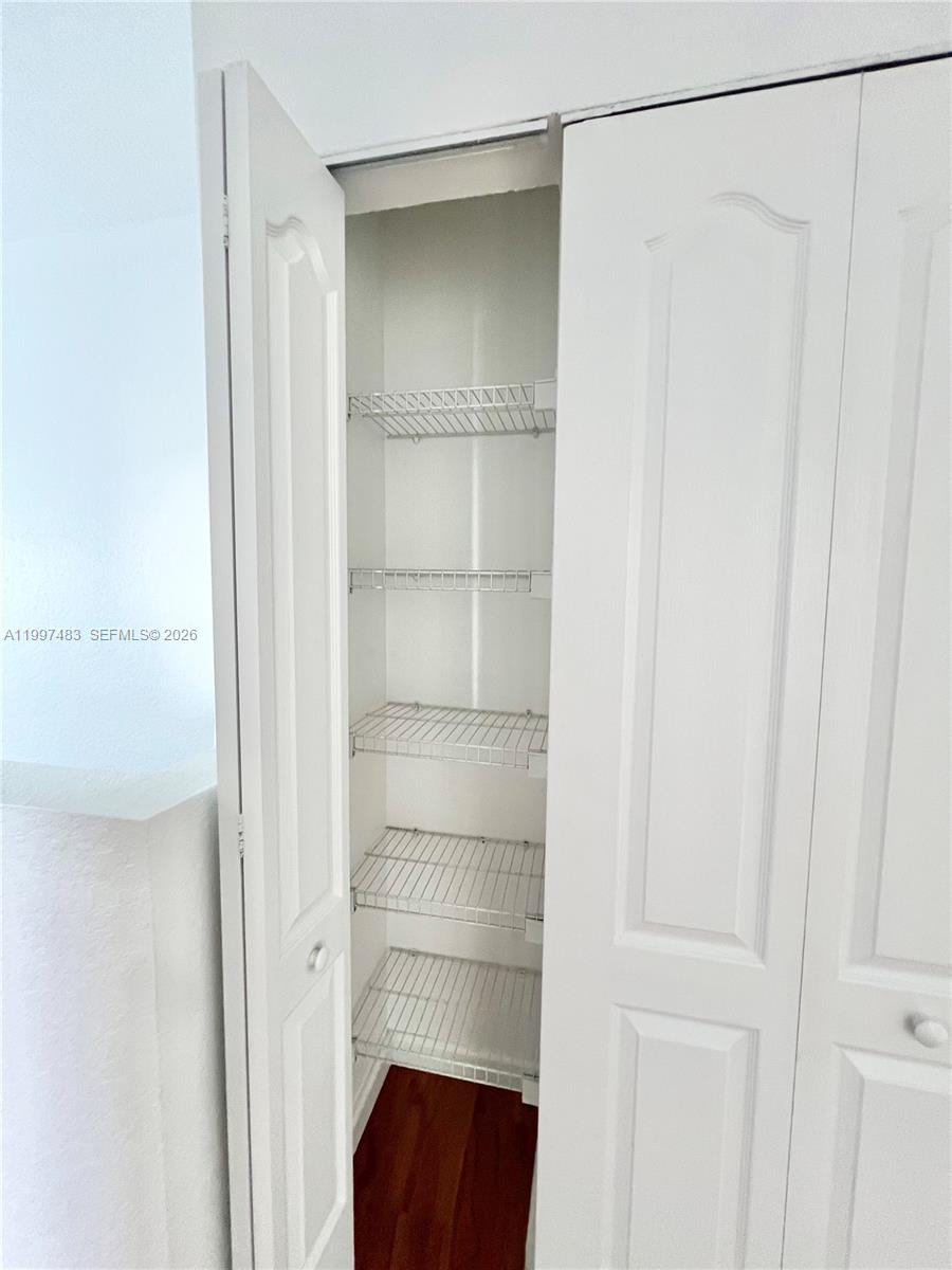 3910 Northeast 13th Drive Homestead, FL 33033 - Photo 14 of 35 a view of walk in closet with empty racks