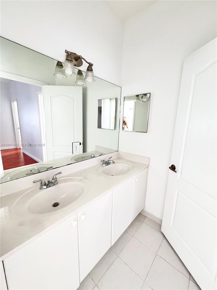 3910 Northeast 13th Drive Homestead, FL 33033 - Photo 16 of 35 a bathroom with a sink and a mirror
