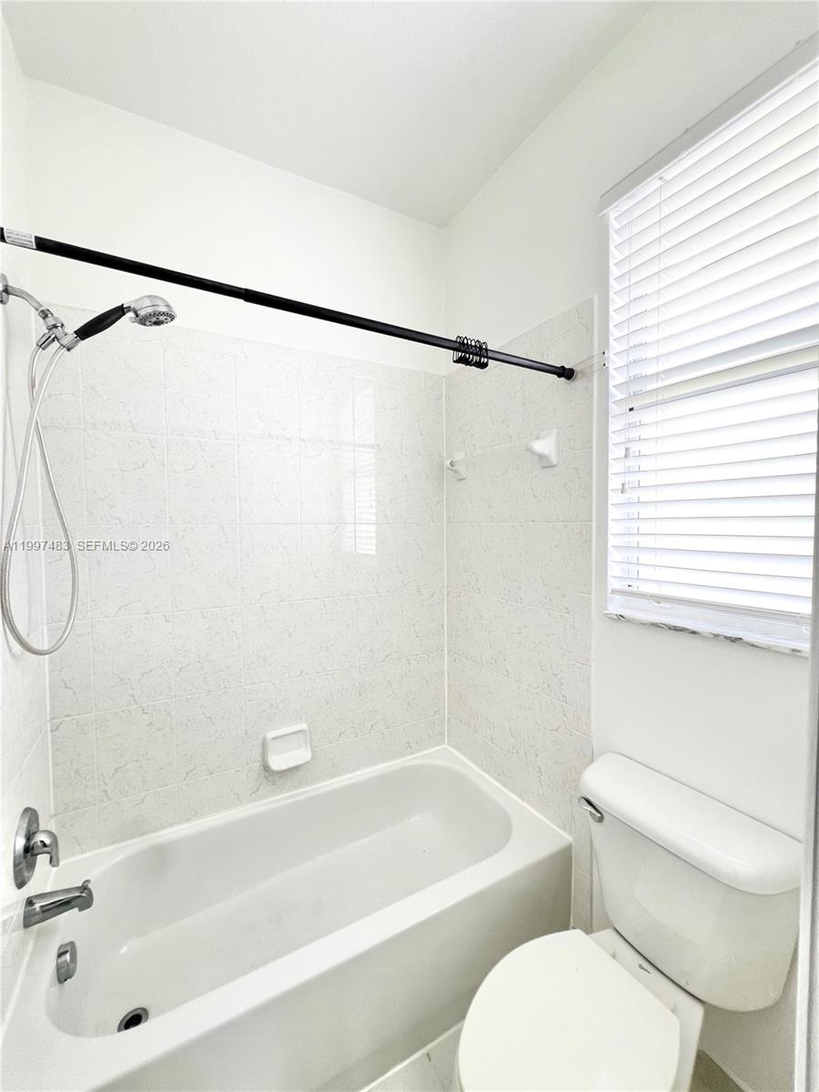 3910 Northeast 13th Drive Homestead, FL 33033 - Photo 17 of 35 a bathroom with a toilet bathtub and shower