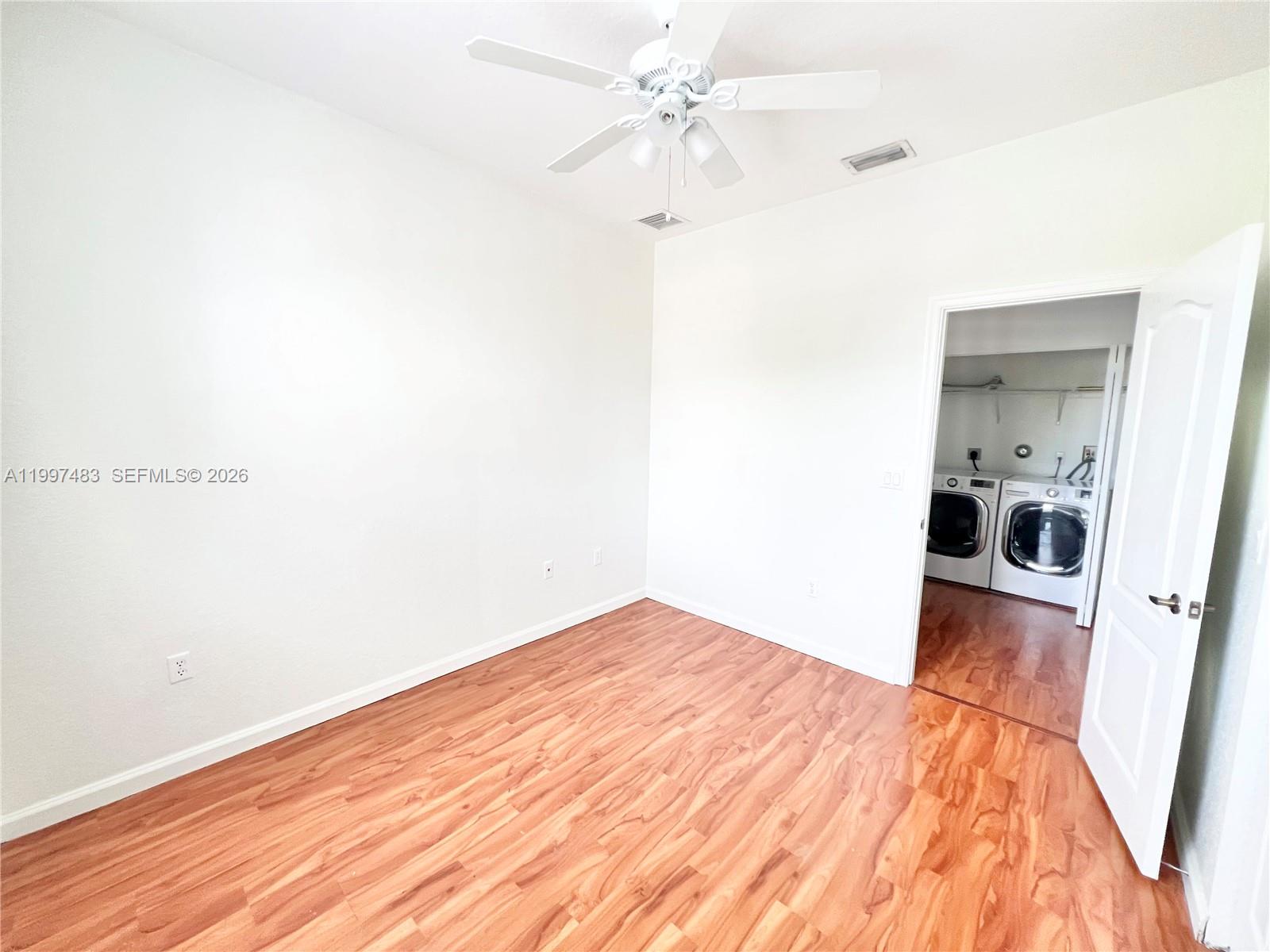 3910 Northeast 13th Drive Homestead, FL 33033 - Photo 18 of 35 a view of a bedroom with wooden floor