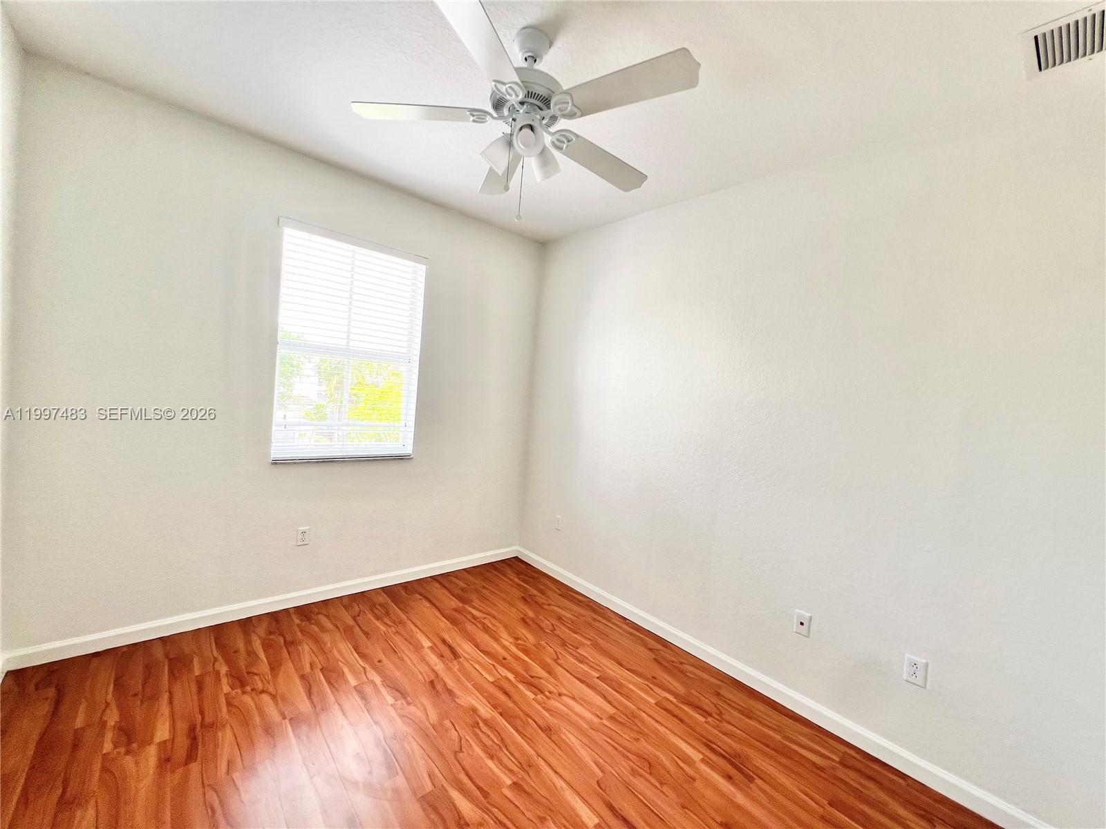 3910 Northeast 13th Drive Homestead, FL 33033 - Photo 20 of 35 an empty room with a window and a ceiling fan